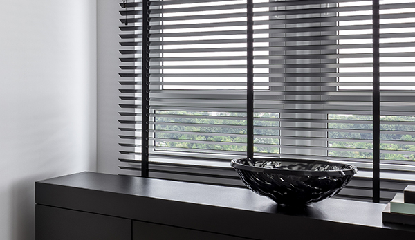 Wood Or Faux Wood Blinds? - Wooden blinds give any room an elegant and stylish appearance, but are they suitable for the room you want them for? We look at the choice between wood and faux wood blinds to let you decide which one is right for your needs.